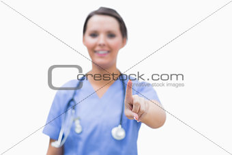 Portrait of surgeon pointing at invisible screen