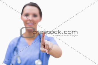 Female surgeon pointing on invisible screen