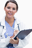 Portrait of smiling female doctor with clipboard