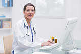 Portrait of female doctor using computer at clinic