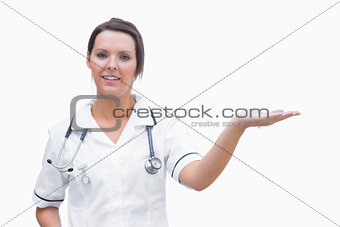 Portrait of female nurse holding out open palm