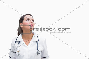 Nurse looking up thoughtfully