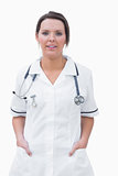Portrait of smiling nurse standing with hands in pockets