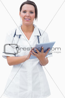 Portrait of young female nurse using digital tablet