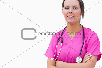 Portrait of smiling nurse standing with arms crossed