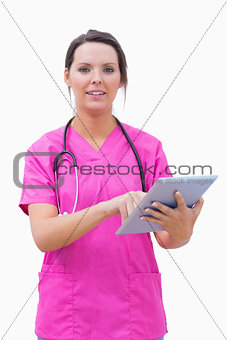 Portrait of young nurse using digital tablet