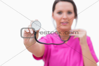 Nurse holding out stethoscope