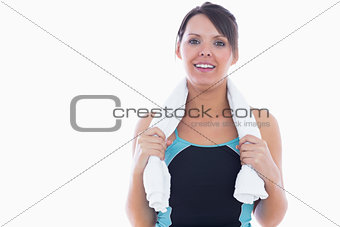 Portrait of woman in sportswear holding towel around neck