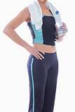 Sporty woman with towel around neck and water bottle