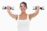 Portrait of young woman exercising with dumbbells