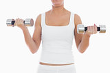 Midsection of woman exercising with dumbbells