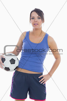 Portrait of young woman in sportswear with football