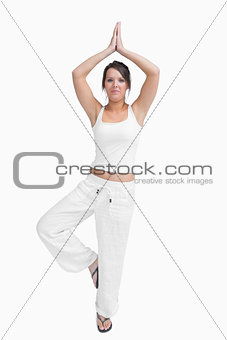 Portrait of woman in sportswear doing the tree pose