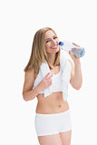 Portrait of smiling woman with towel around neck drinking water