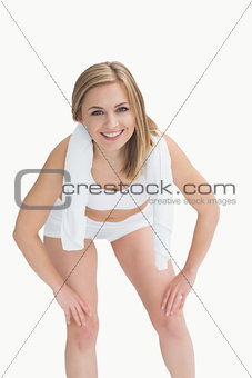 Portrait of woman in sportswear with towel around neck