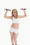 Portrait of young woman exercising with dumbbells