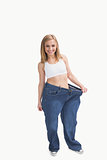 Portrait of woman wearing old pants after losing weight