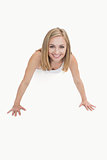 Portrait of happy young woman doing pushups