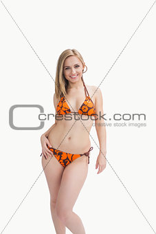 Portrait of happy young woman posing in bikini