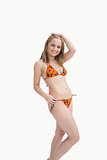 Portrait of happy young woman posing in bikini