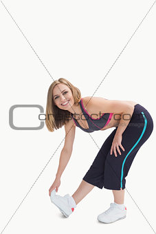 Portrait of young woman doing stretching exercise