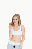 Portrait of happy young woman holding cookie