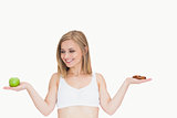 Portrait of smiling woman holding apple and cookie