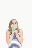 Happy young woman kissing fanned dollars