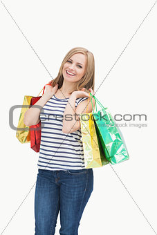 Portrait of cute young woman with shopping bags