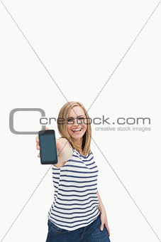 Portrait of casual woman showing you her new smartphone