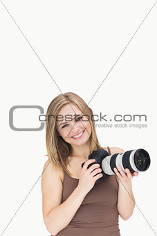 Portrait of happy female with photographic camera