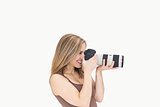 Side view of female photographer with photographic camera
