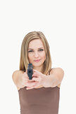 Portrait of casual woman aiming gun towards you