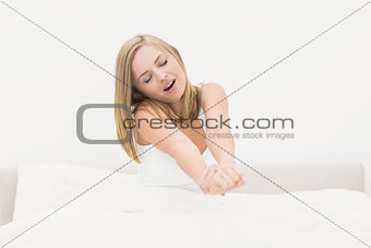 Woman yawning in bed