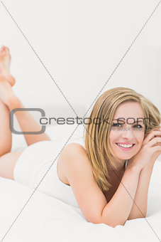 Portrait of beautiful relaxed woman lying in bed