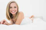 Portrait of beautiful happy woman in bed