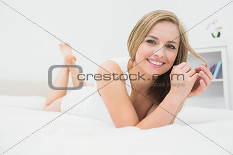 Portrait of beautiful happy woman in bed