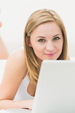 Portrait of beautiful happy woman using laptop