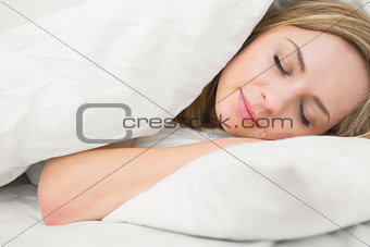 Beautiful woman sleeping with eyes closed in bed