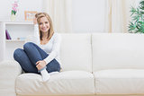 Casual happy woman sitting on sofa