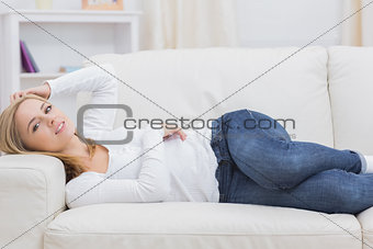 Portrait of casual young lying on sofa