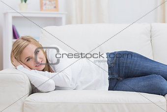 Portrait of casual woman lying on sofa