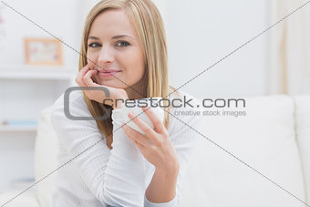 Portrait of woman with tea cup at home