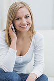 Portrait of casual woman using mobile phone at home