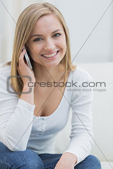 Portrait of casual woman using mobile phone at home