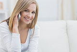 Portrait of casual young woman using mobile phone at home