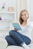 Portrait of happy woman with storybook at home