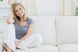 Portrait of relaxed woman sitting on couch
