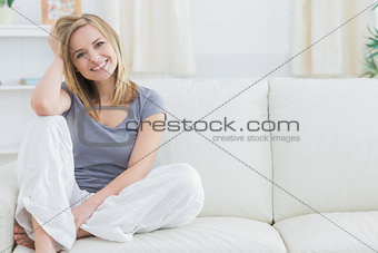 Portrait of relaxed woman sitting on couch