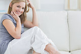 Portrait of smiling woman sitting on couch